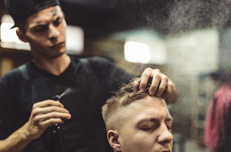 stylist-grooming-client-in-barbershop-PDUS6UN.jpg
